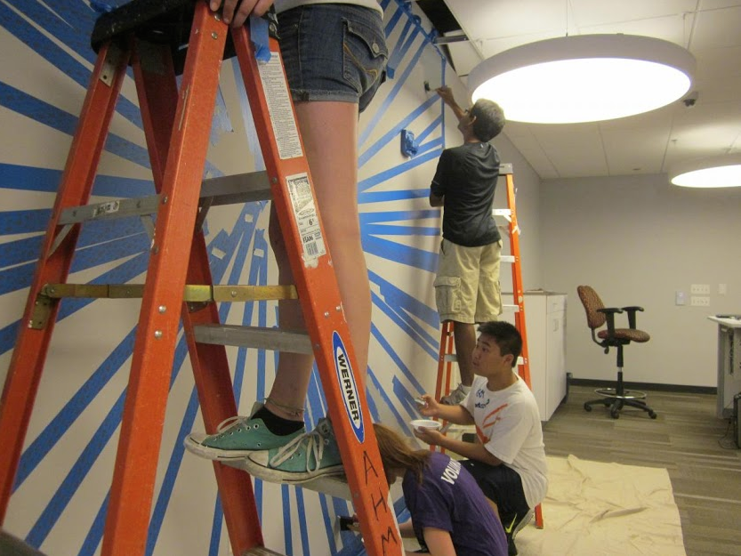 The Teen Advisory Board builds a floor-to-wall clock at the Arlington Heights Memorial Library.