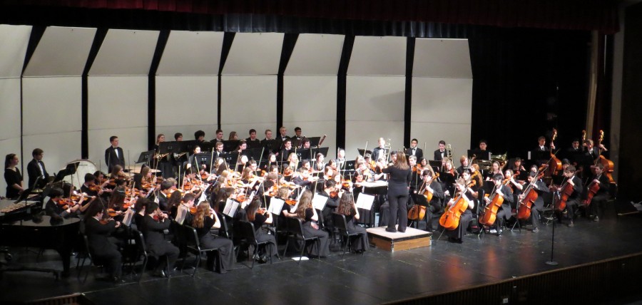 Orchestra sets up for the piece “Danse Bacchanale” at concert in the theatre.