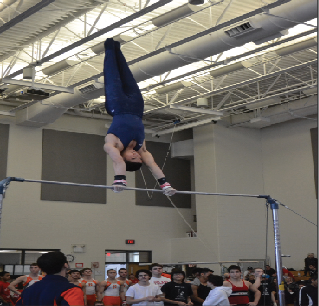 Senior Tyler Cho performs on the bars