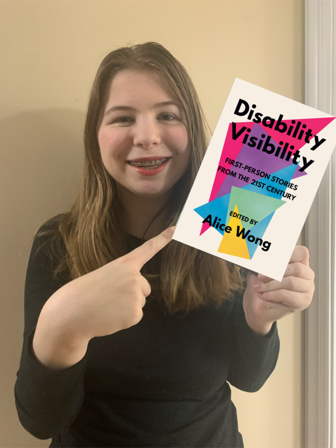 Emily Luethy displays a copy of the book "Disability Visibility".