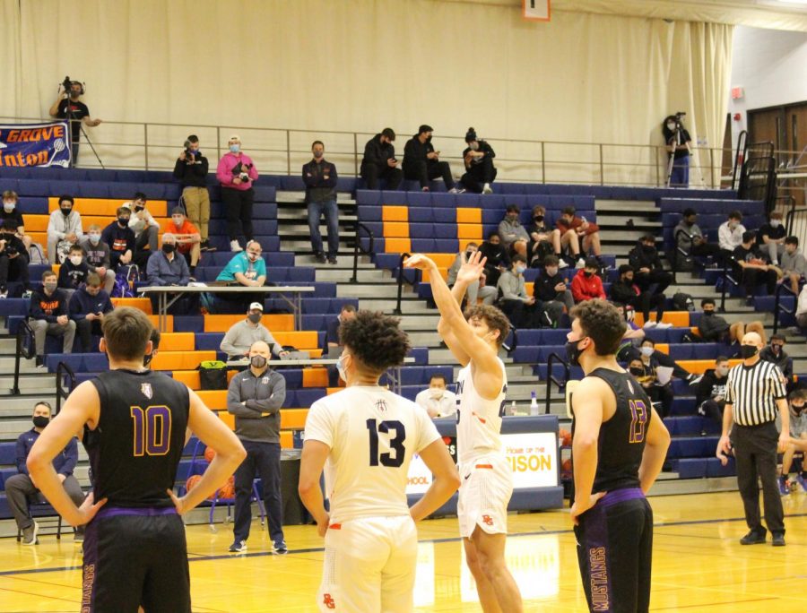 Ayden Anderson takes a free throw shot at line as teammate, Stephen Harris prepares to defend.