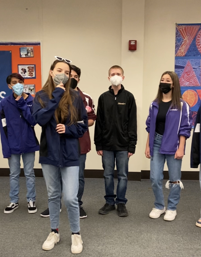 Sing Your Heart Out: A few members of the different a Capella groups deliver a singing valentine on Feb. 14 during a second hour English class.