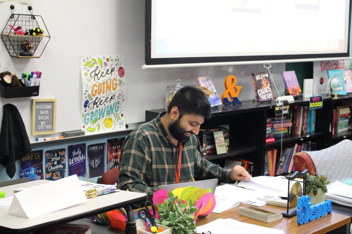 First year teacher Hassan Waseem putting in grades and taking attendance